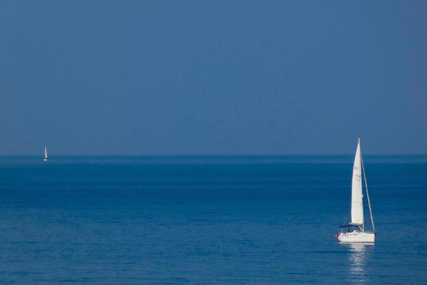 Solitary sailboat on the mediterranean coast of the Catalan Costa Brava photo