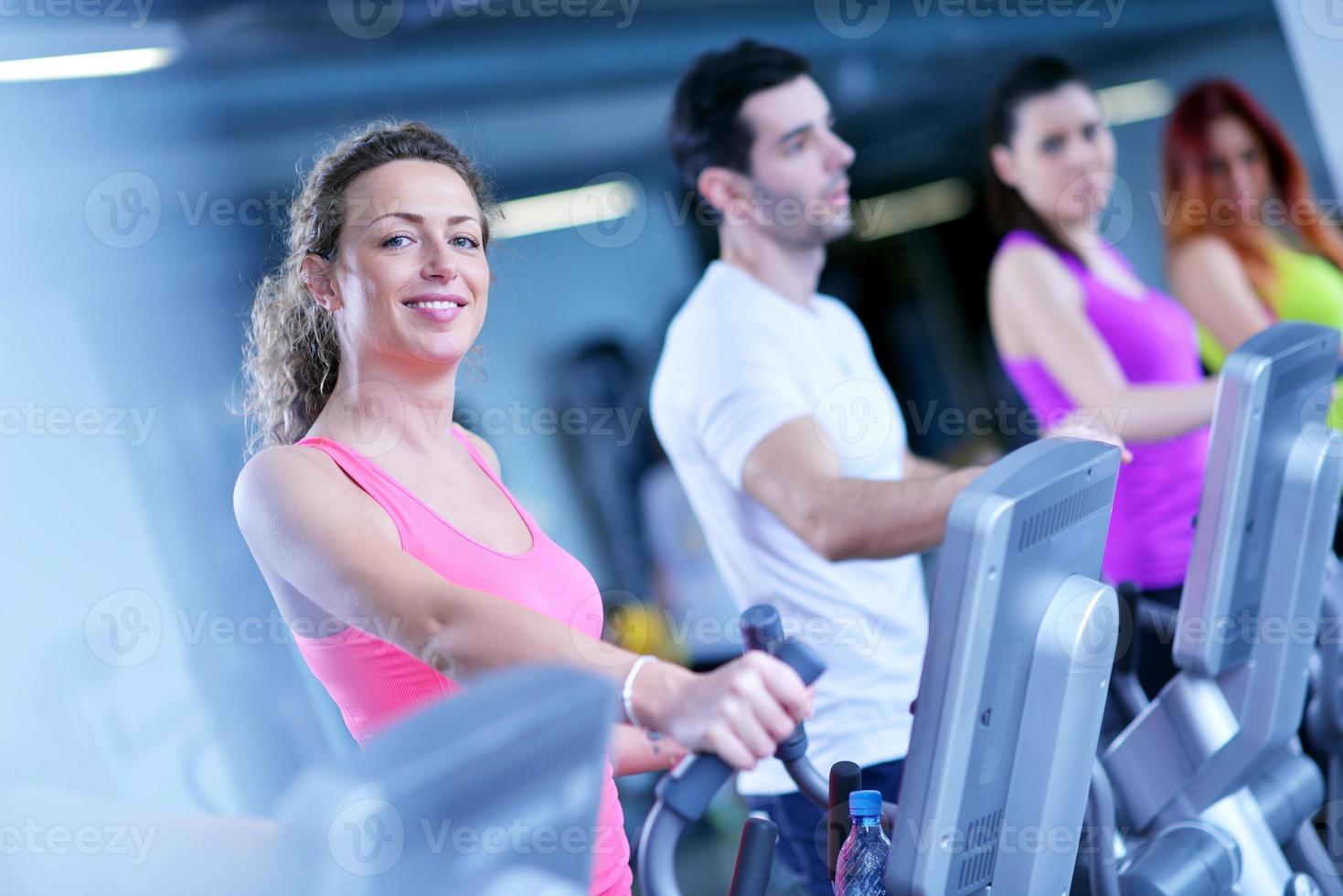 Group of people running on treadmills photo