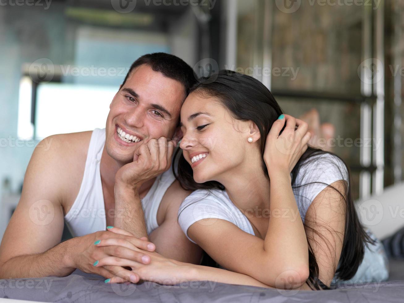 couple relax and have fun in bed photo