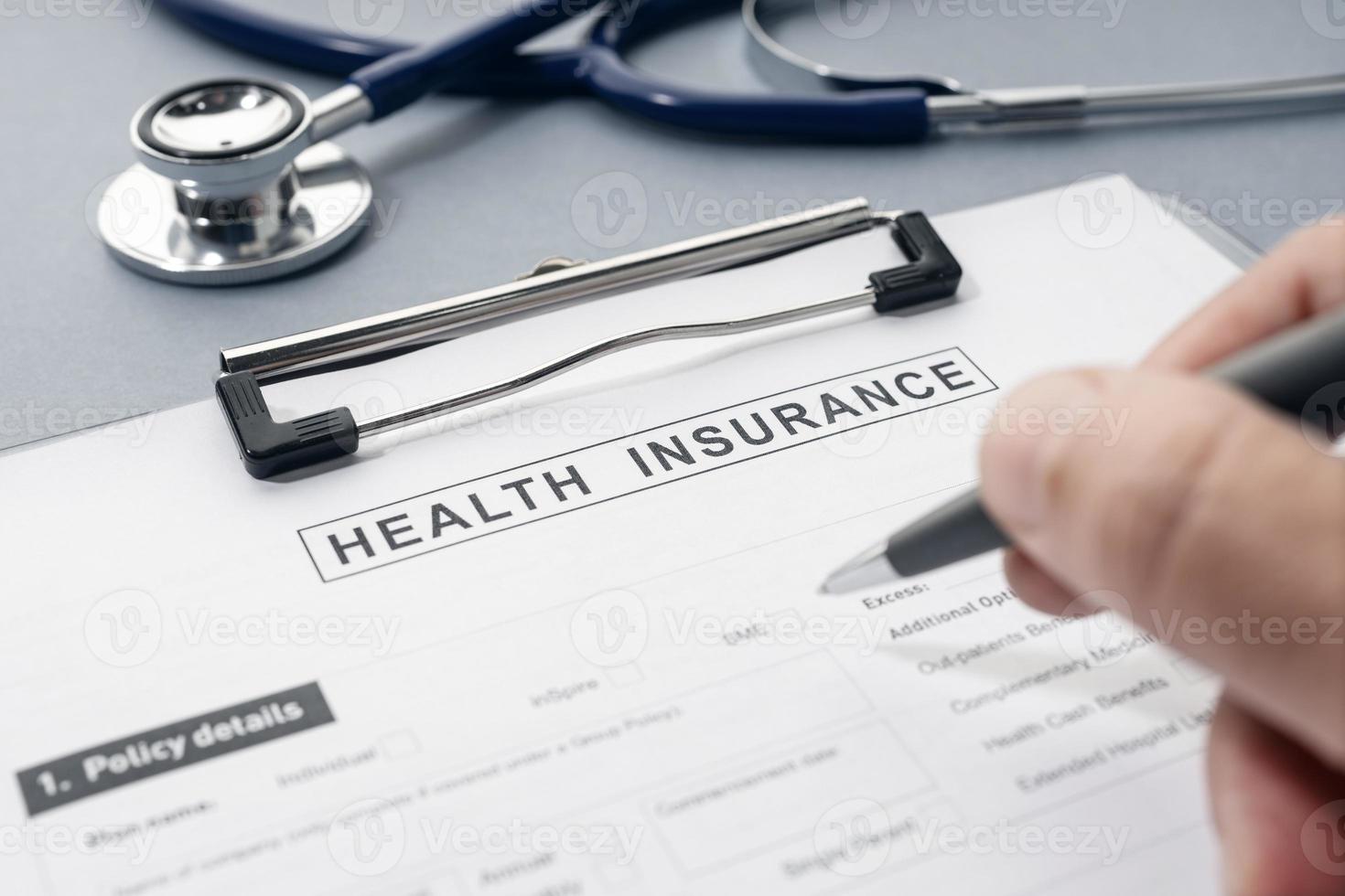 Health Insurance form and stethoscope on desk photo