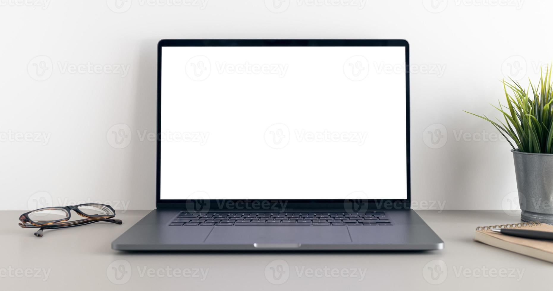 Modern laptop with blank white screen on minimalist desk. Mock up template photo