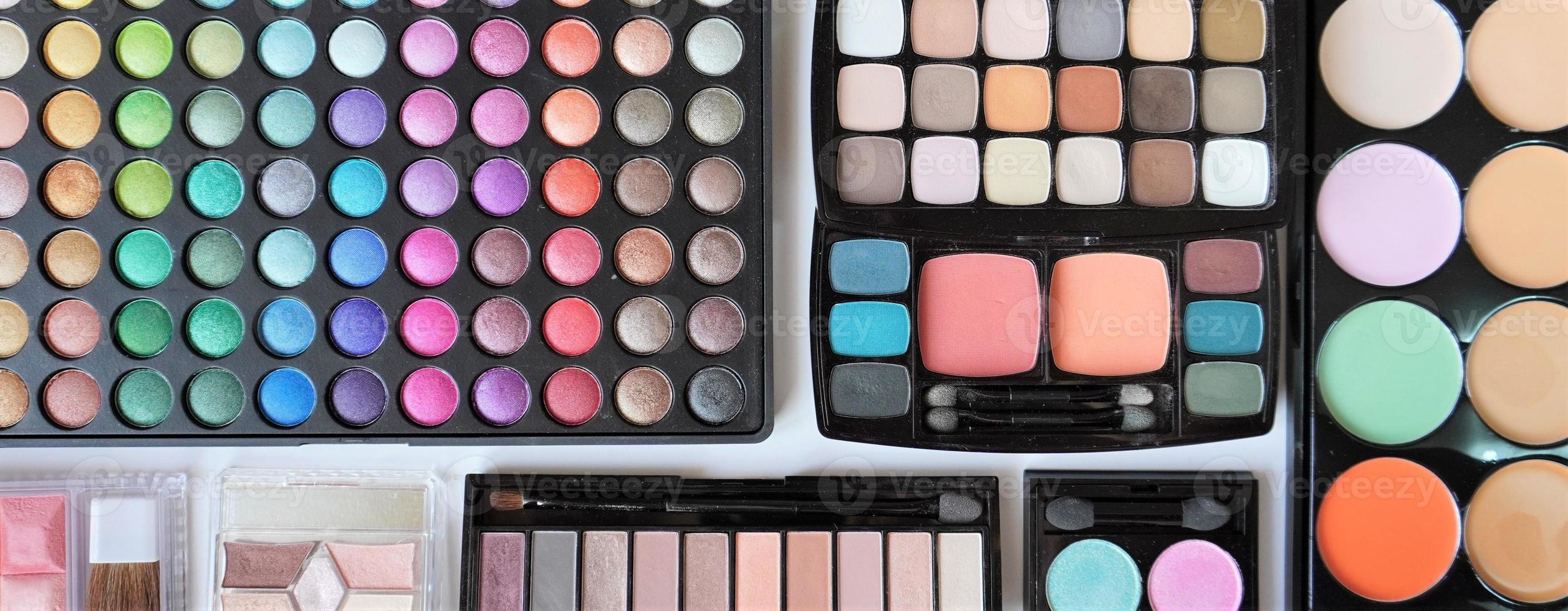 Collection of various cosmetic products. Make up eyeshadow palettes. photo