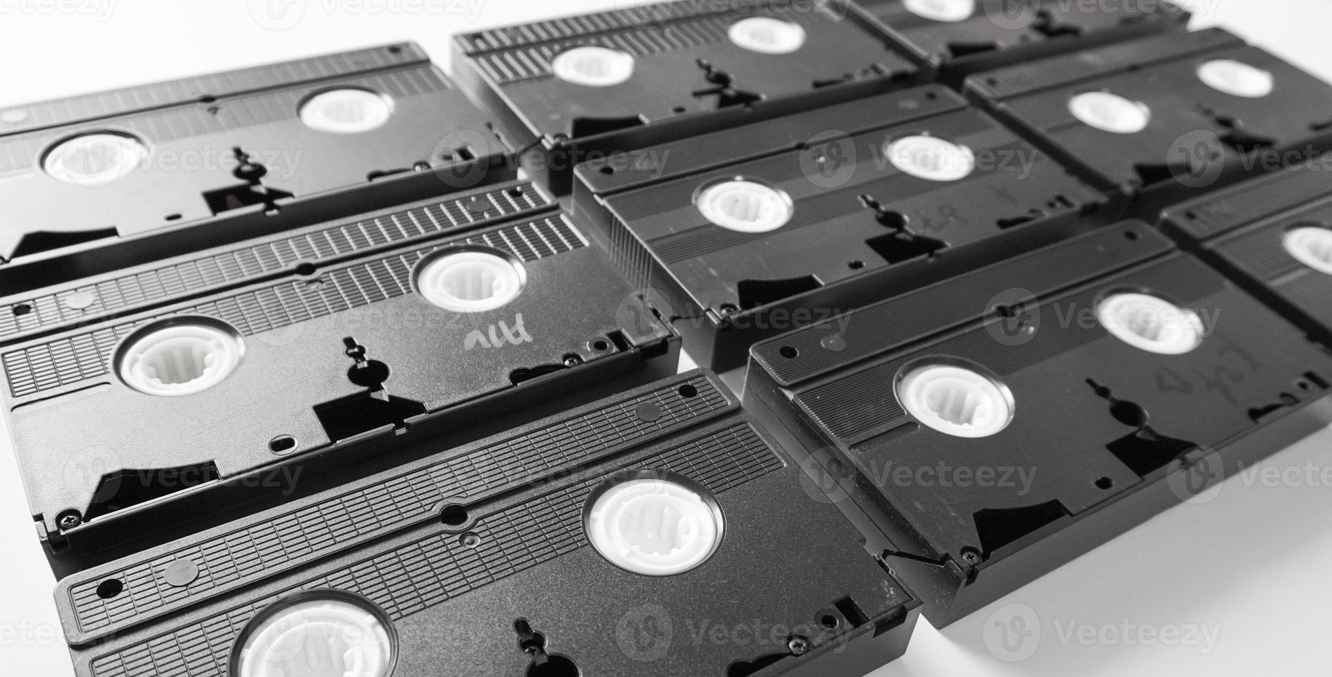 VHS tapes neatly arranged. Video Home System tape cassette on white background. photo
