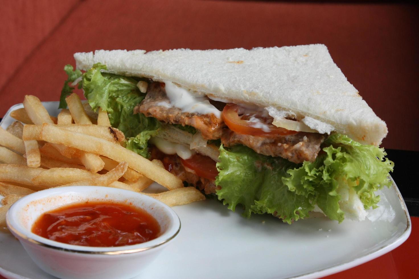 Triangular sandwiches. With stuffing burger meat, mayonnaise. Comes with french fries. close up photo