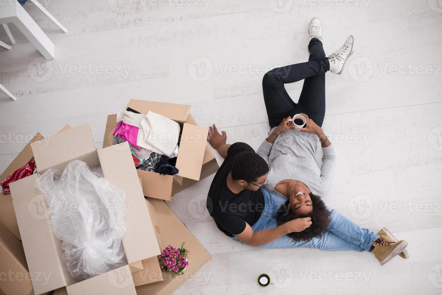 African American couple relaxing in new house photo