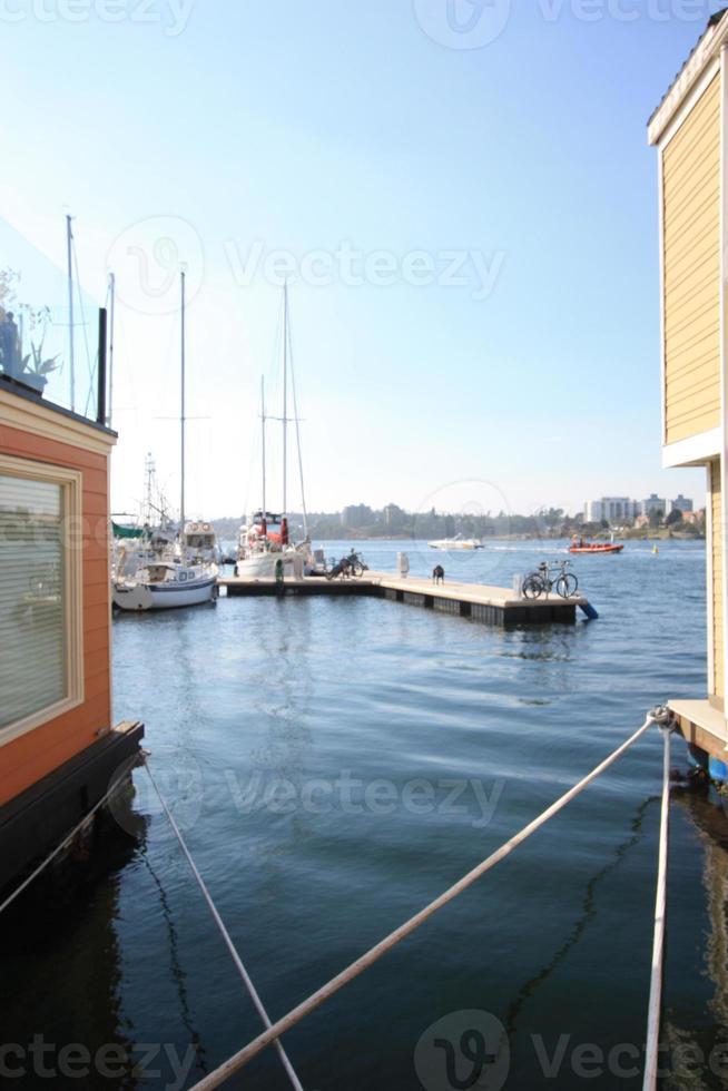 A shot of a boat pier shot between two float homes. photo