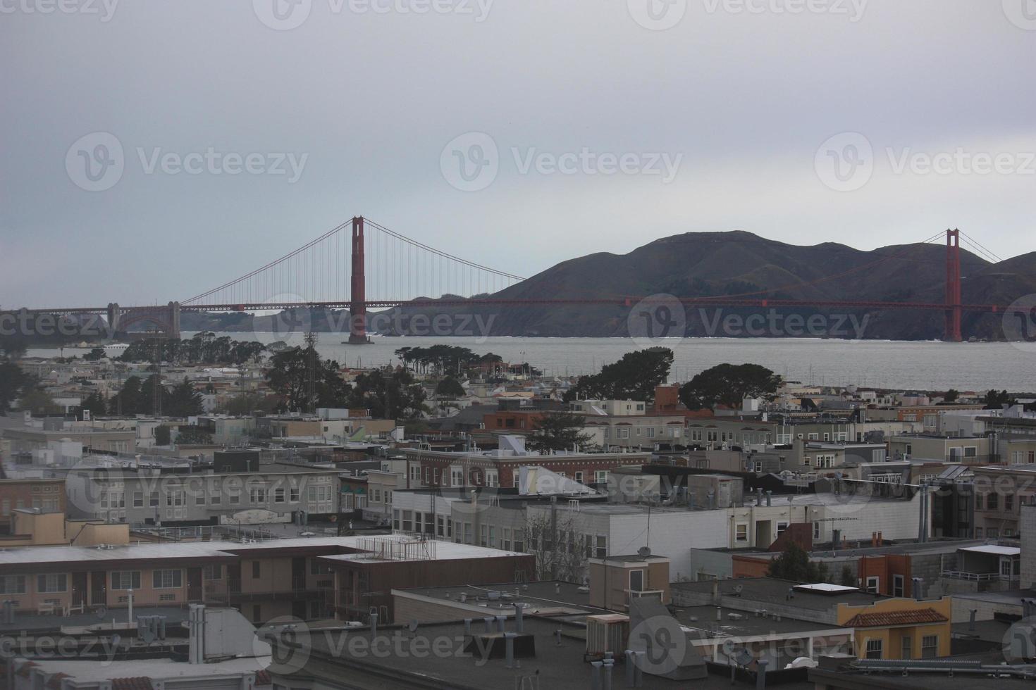 Taken at dusk a city skyline with the Golden Gate Bridge in the background. photo