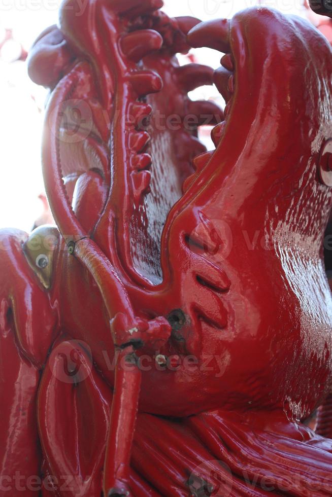 A close up of red dragon statue guarding Chinatown. photo