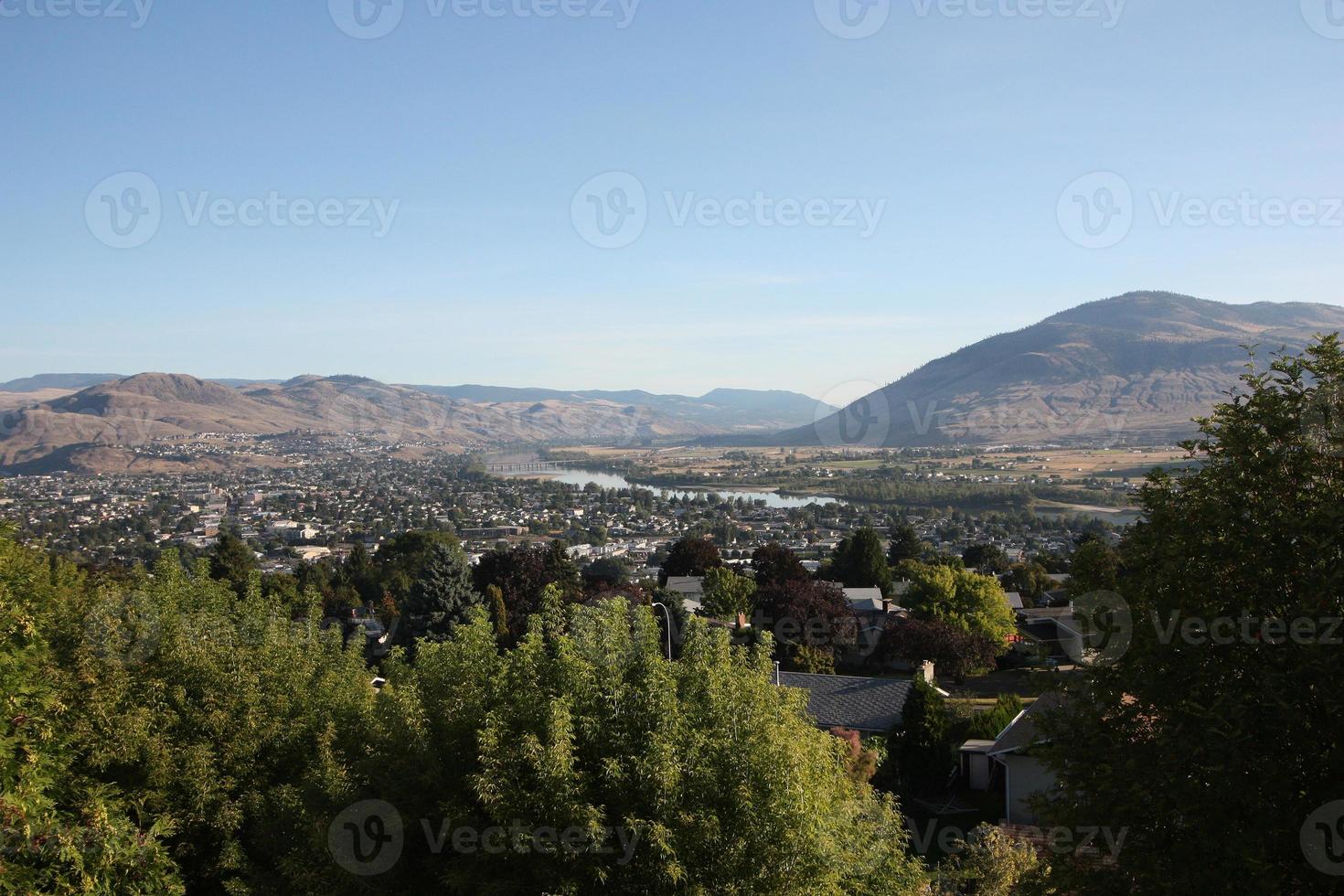 A city and river nestled in a valley. photo