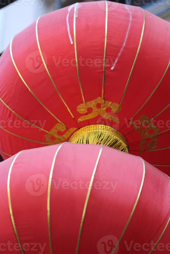 Two red Chinese lanterns hanging in Chinatown. photo