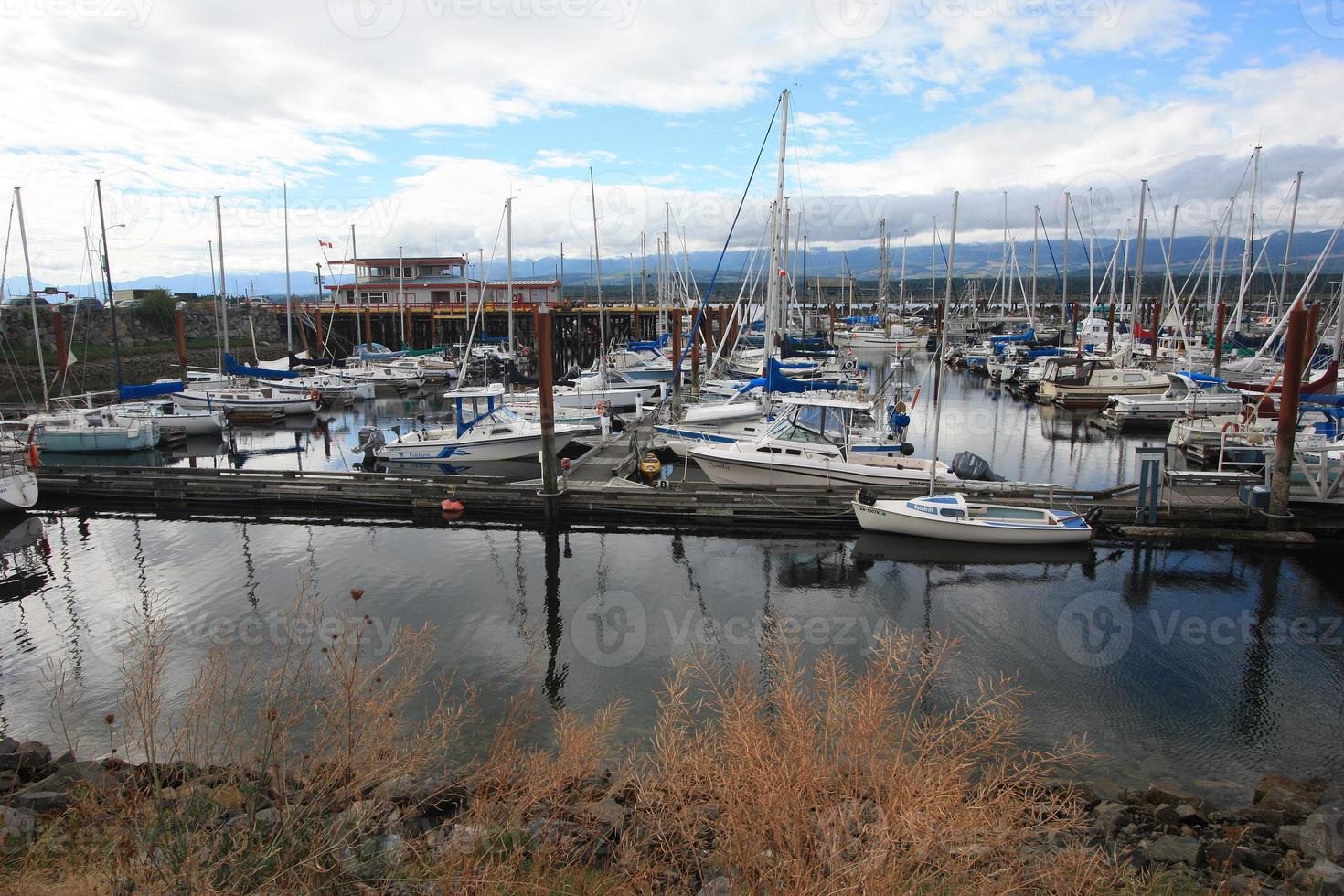 A boat dock with a reflection on the water. photo