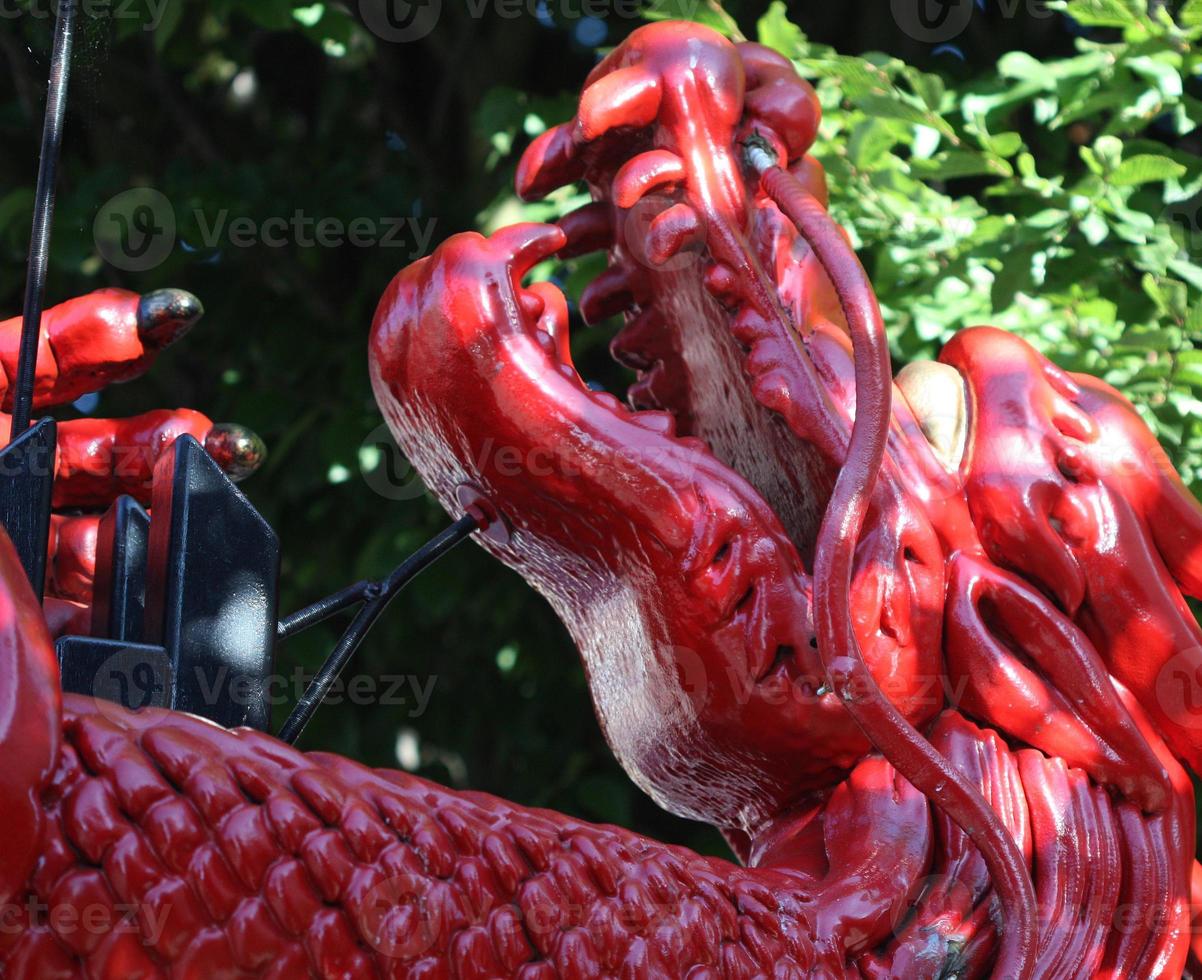 A side view or profile of a red Chinese dragon guarding china town. photo