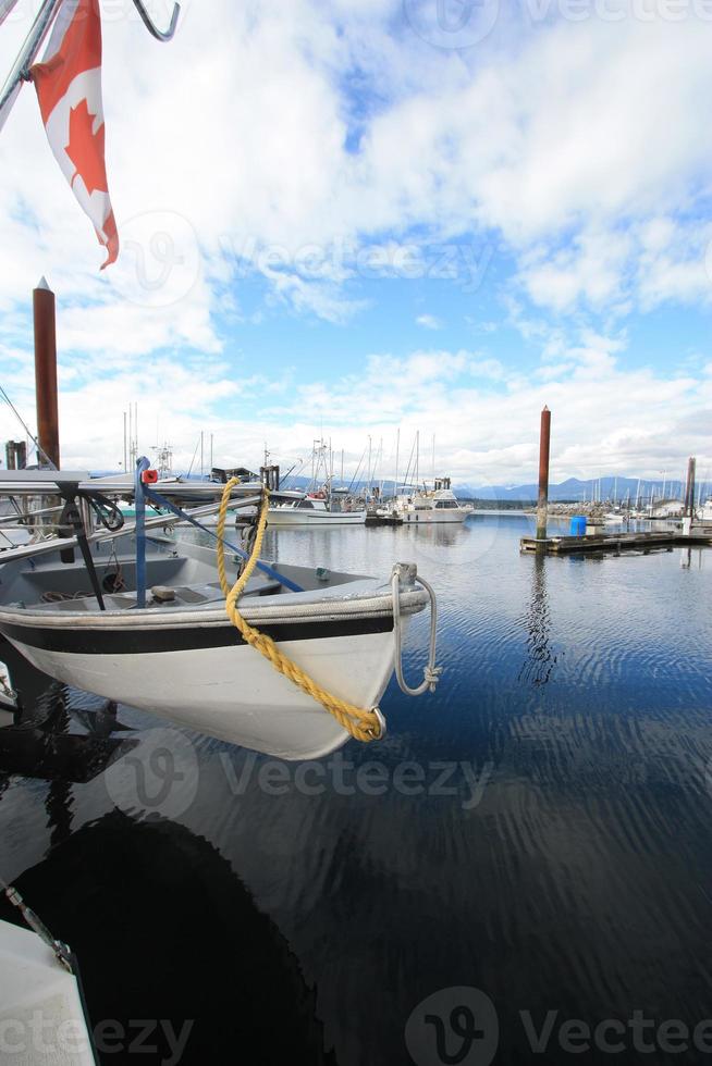 A boat marina with a yacht flying the Canadian flag. photo