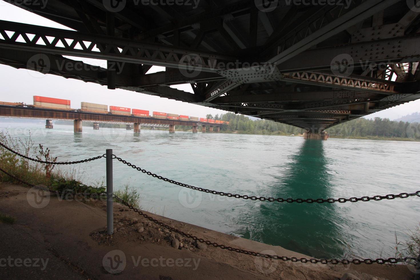A shot of a railway bridge shot under another bridge. photo