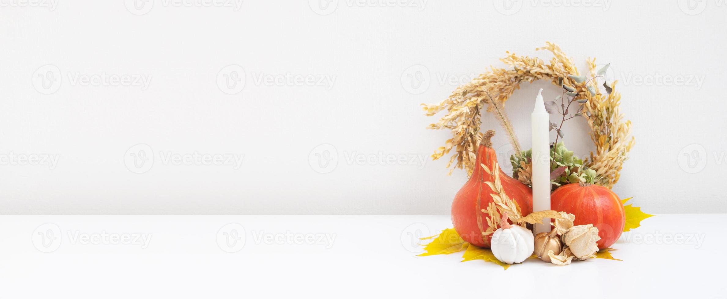 Autumn composition. Dried leaves, pumpkins and candles on white background. Autumn fall and thanksgiving day concept. Still life photo