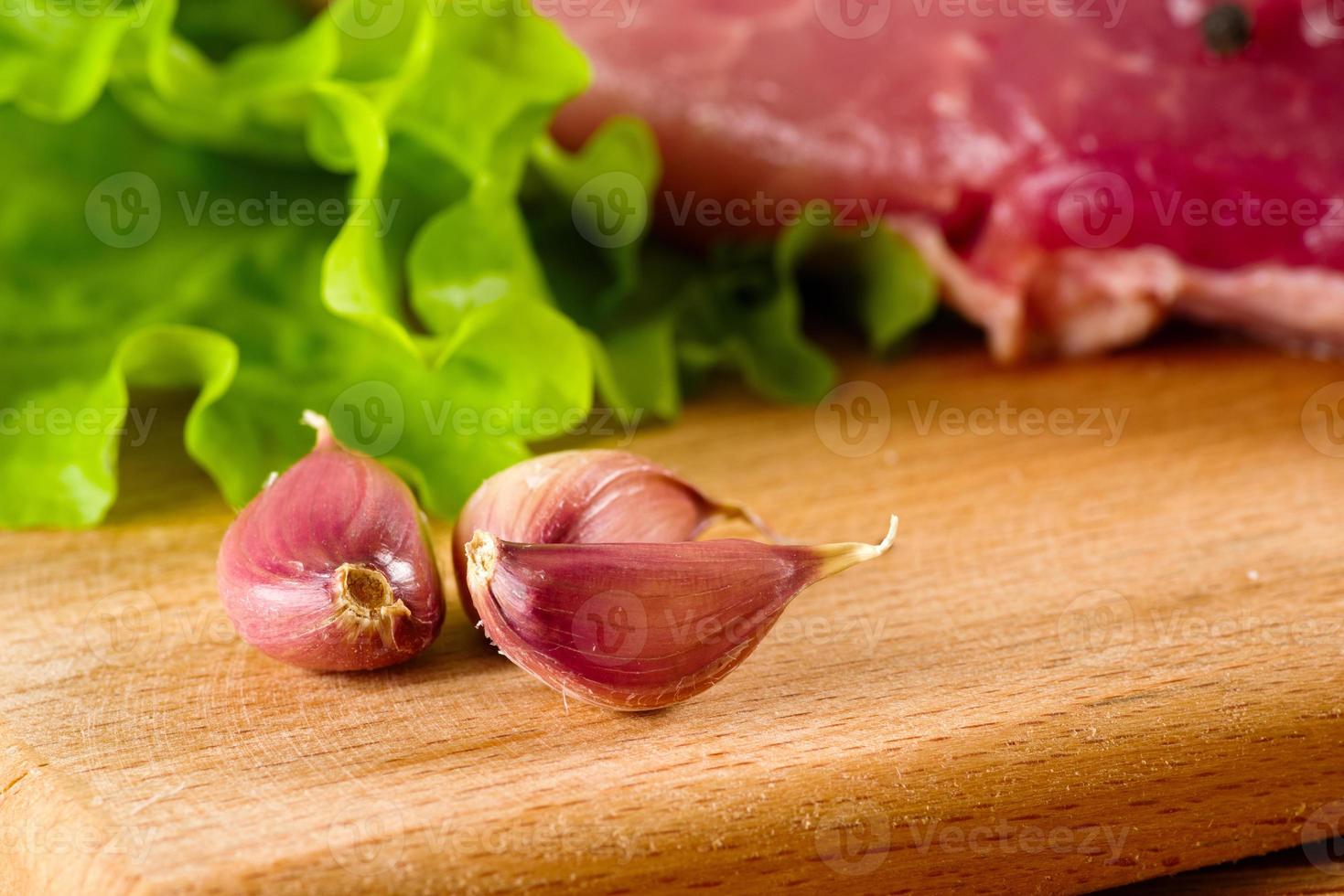 garlic peeled on a board photo