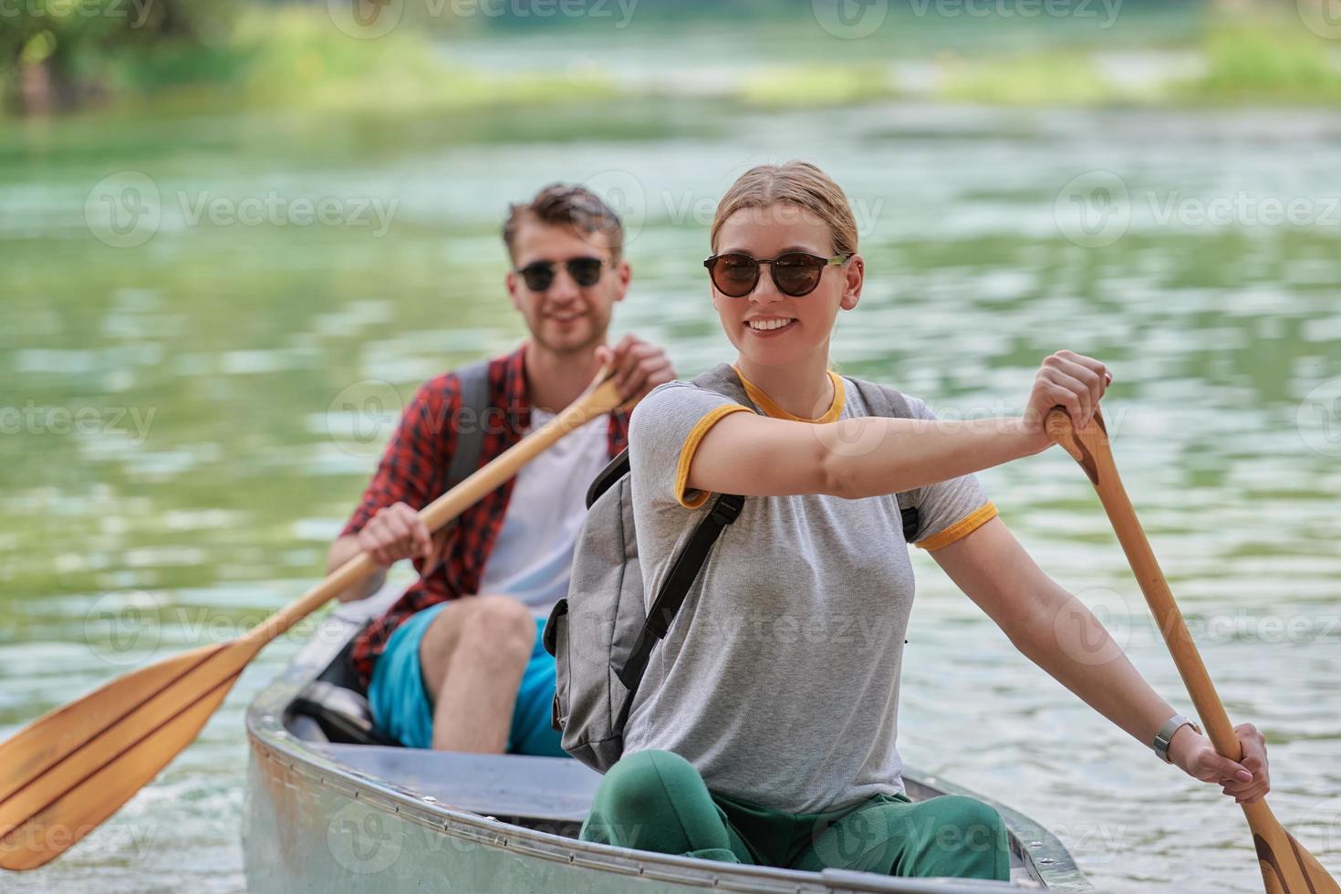 friends are canoeing in a wild river photo