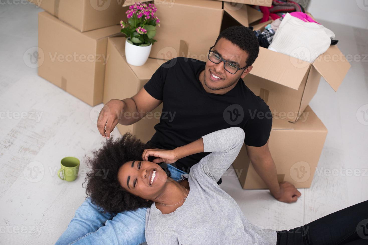 African American couple relaxing in new house photo