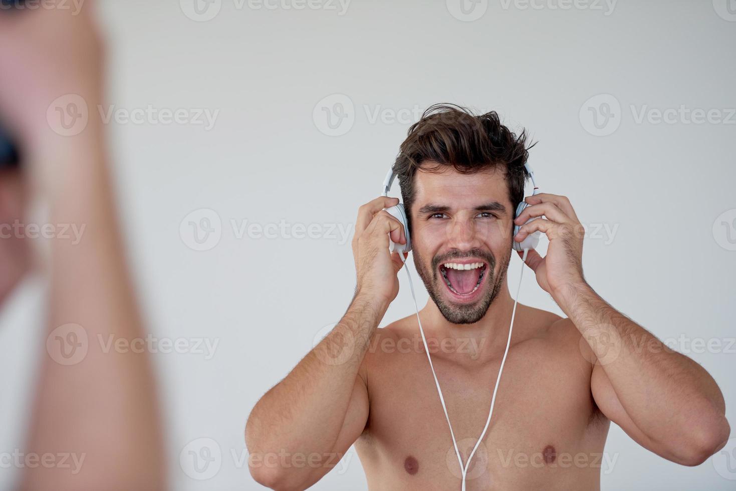 handsome young man listening music on headphones photo
