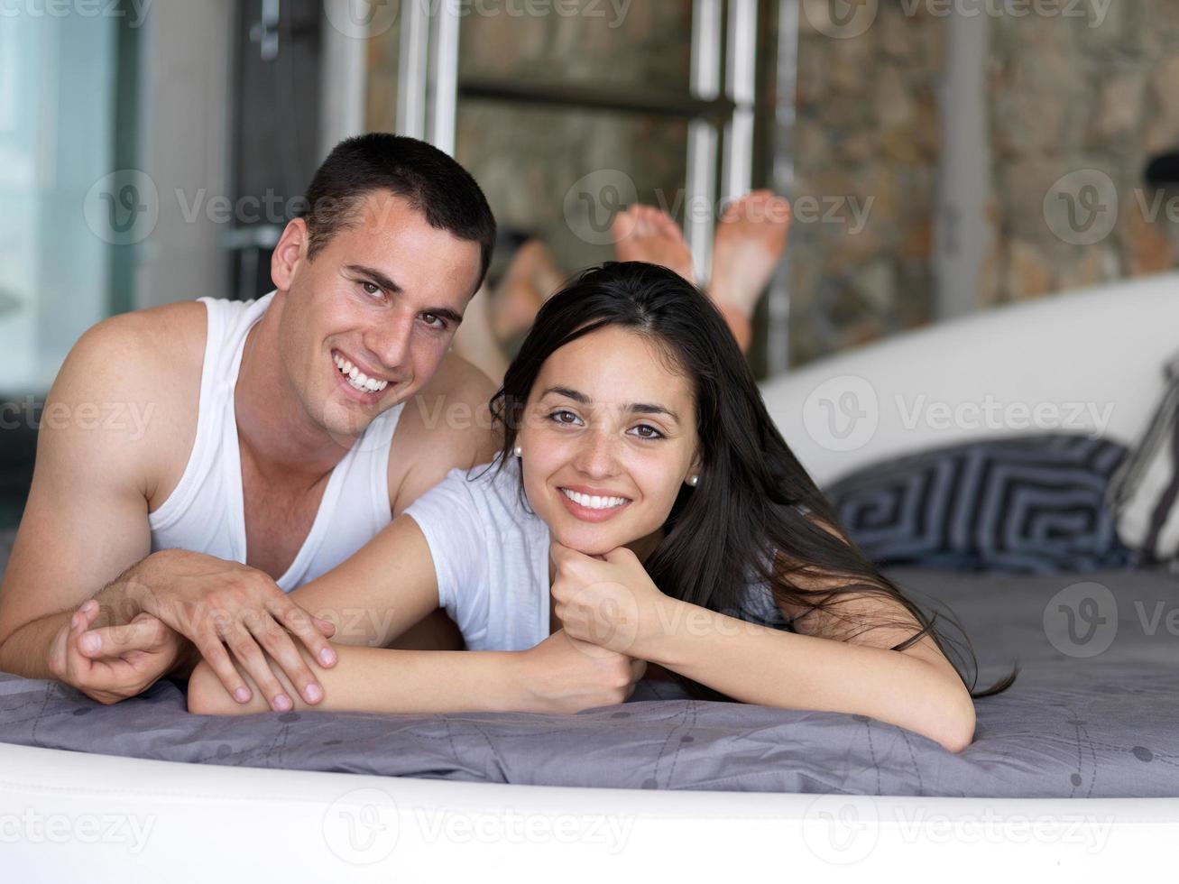 couple relax and have fun in bed photo