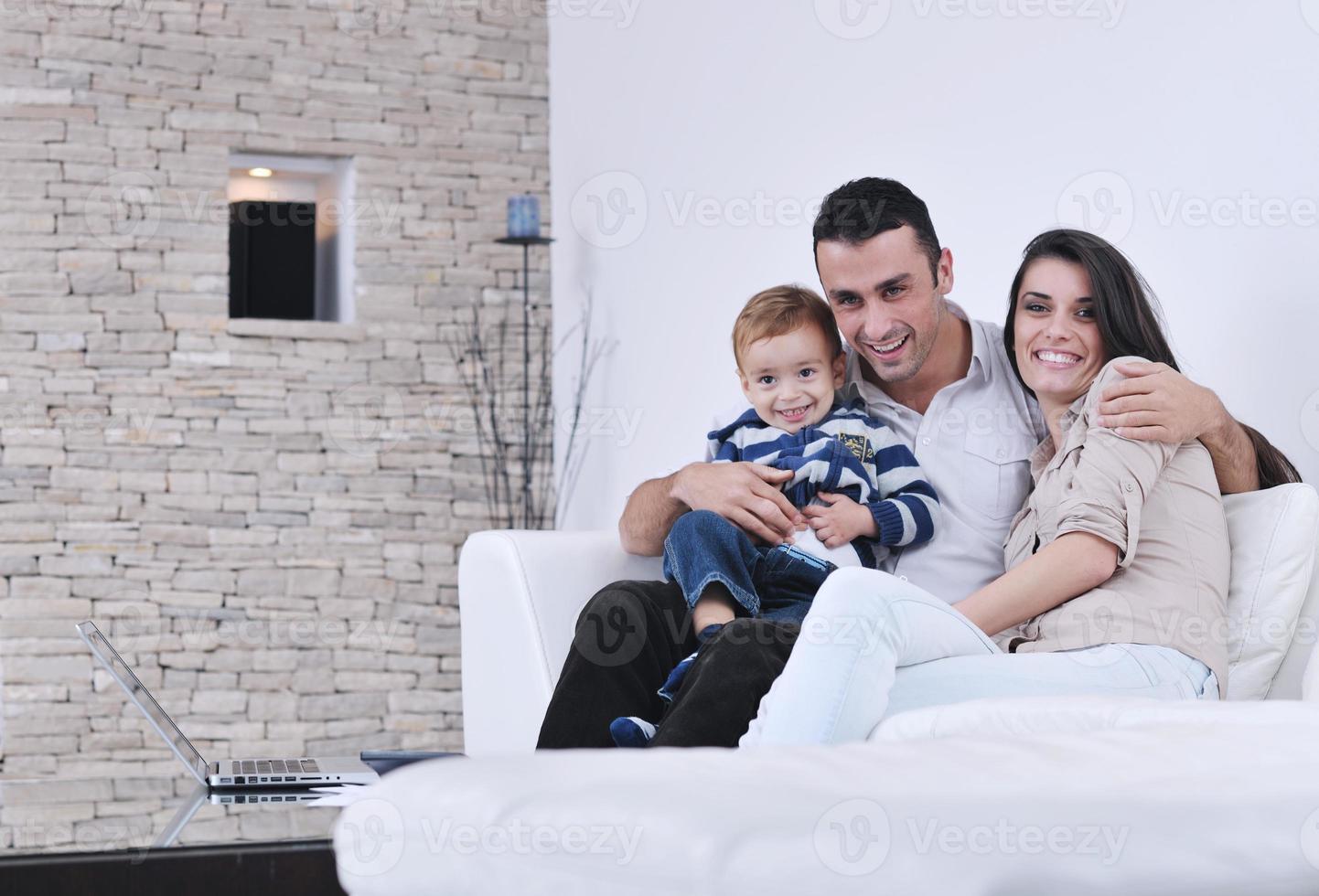 happy young family have fun  with tv in backgrund photo