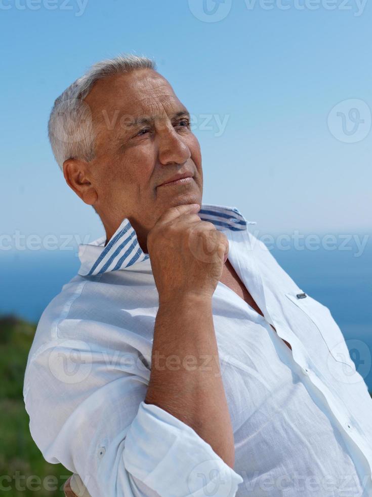 senior man sitting outside photo