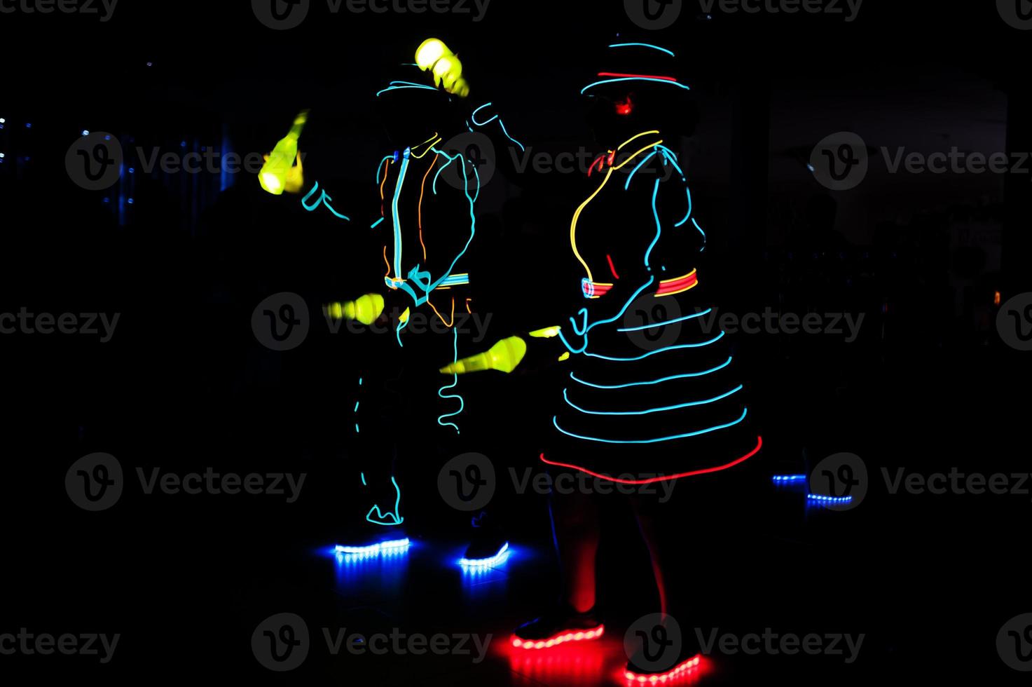 Professional barman and led light show. Silhouette of modern bartender shaking drink at night cocktail bar. photo