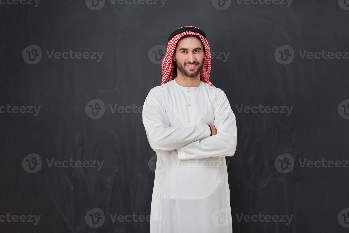 Young muslim man with crossed arms smiling photo