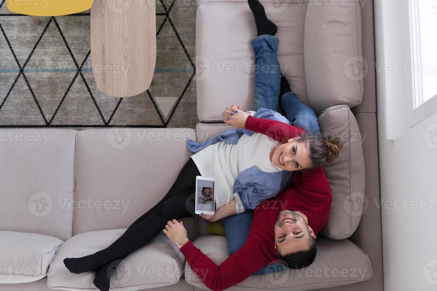 couple relaxing at  home with tablet computers photo