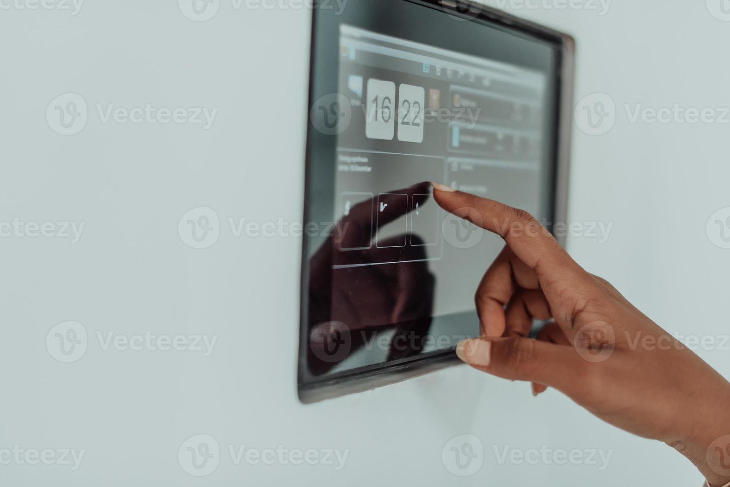 African woman using smart home screen control system photo