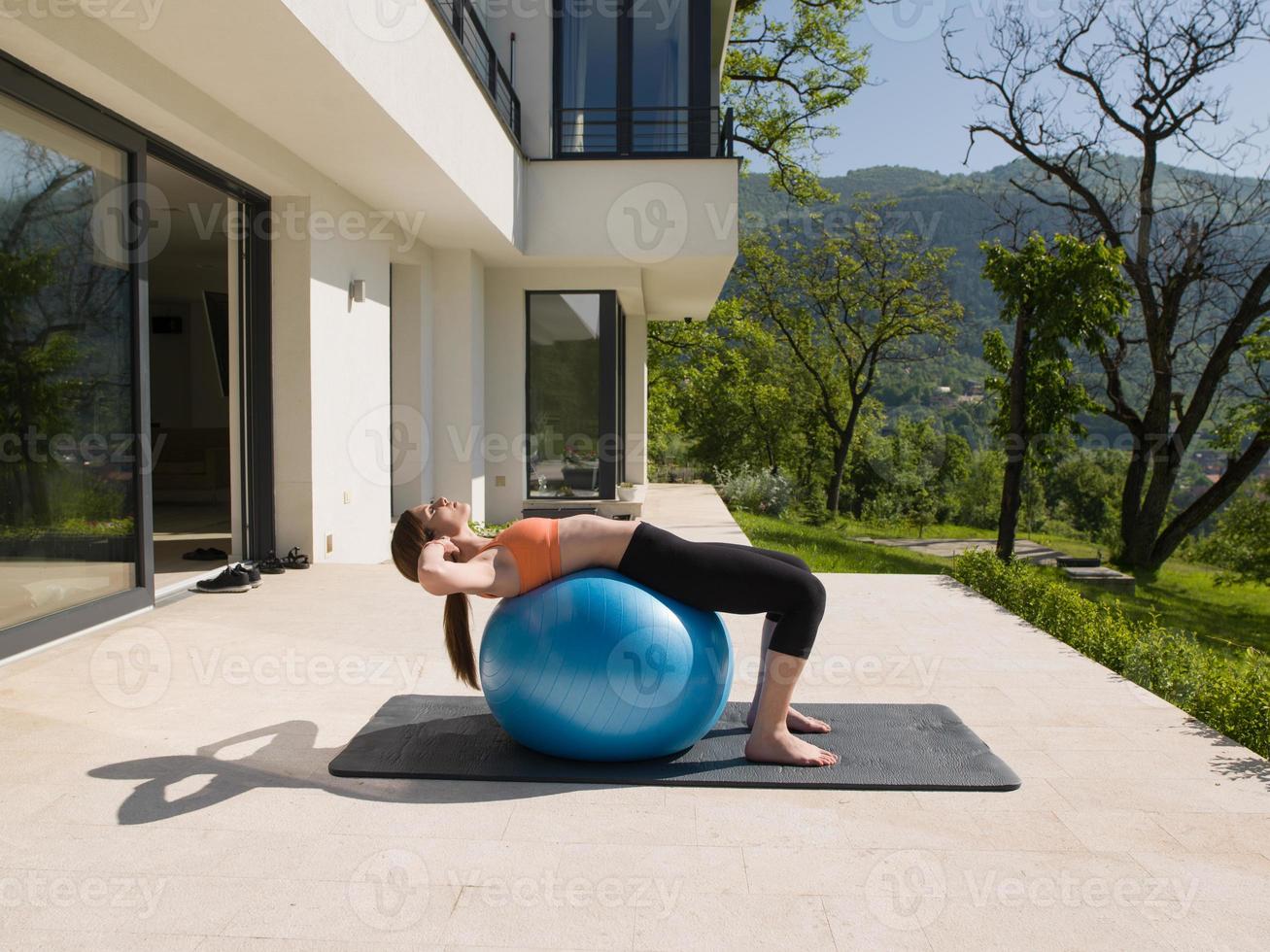 woman doing exercise with pilates ball photo