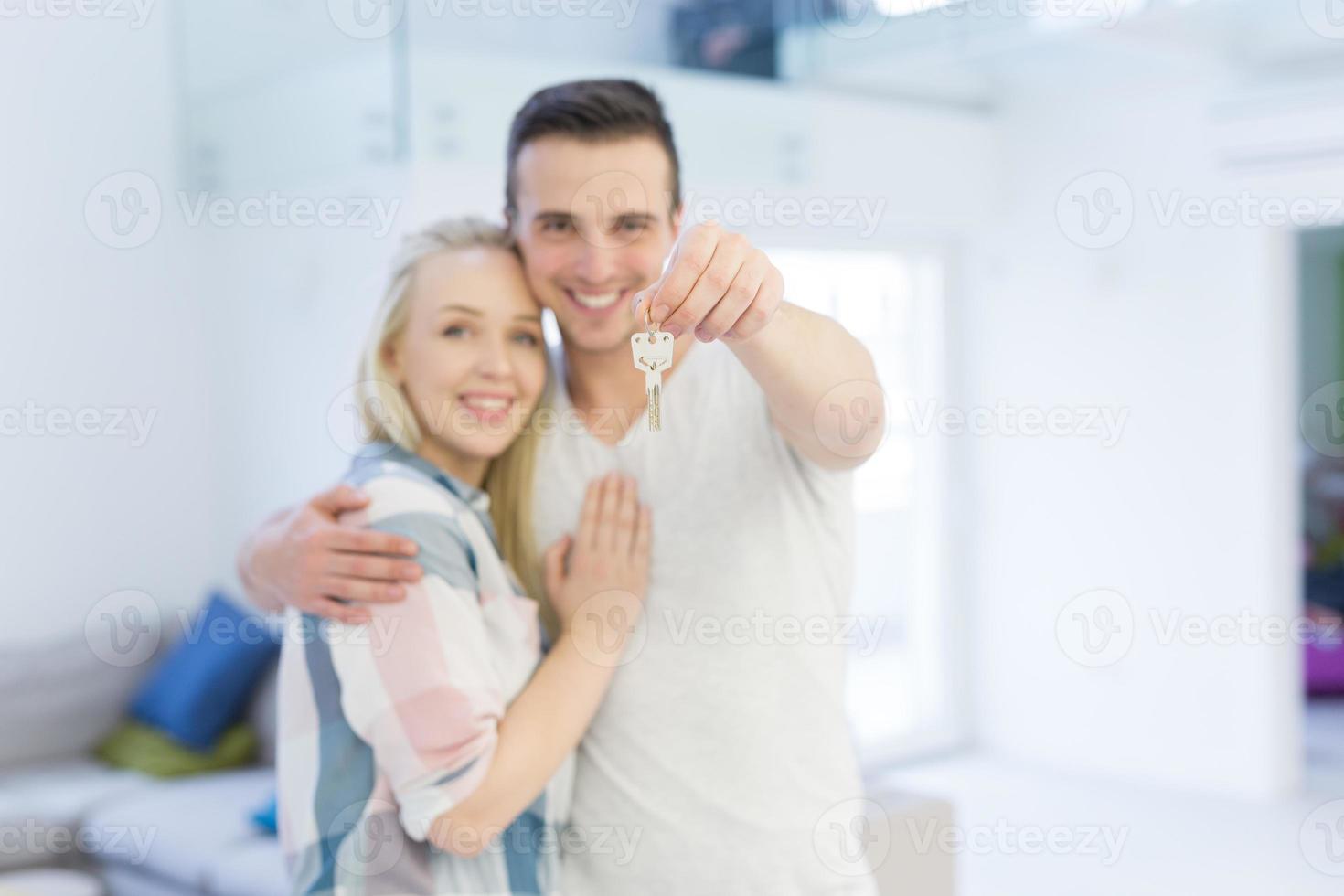 couple showing a keys of their new house photo