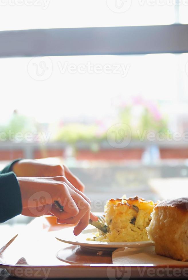 Cutting up lasagna photo