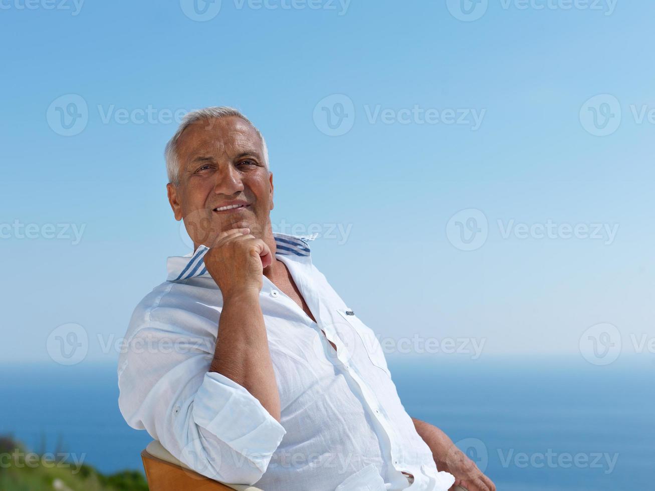senior man sitting outside photo