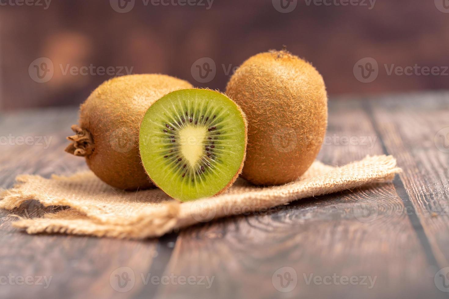 A half of kiwi on the wooden table photo