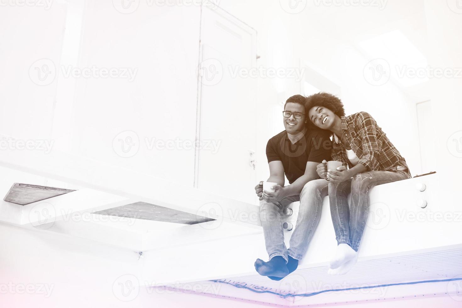 couple having break during moving to new house photo