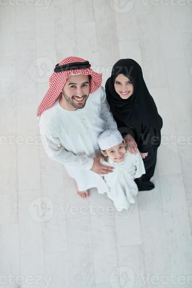 Top view of young arabian muslim family wearing traditional clothes photo