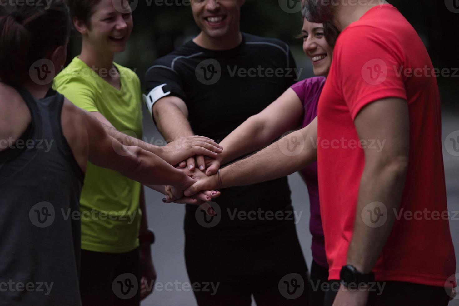 runners giving high five to each other photo