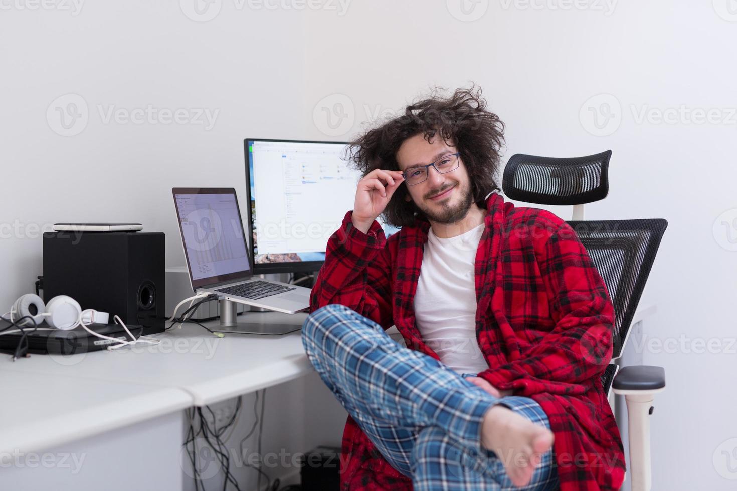 graphic designer in bathrobe working at home photo