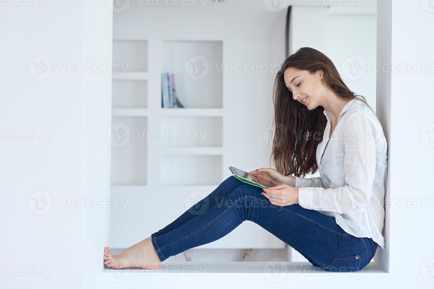 woman at home using tablet photo