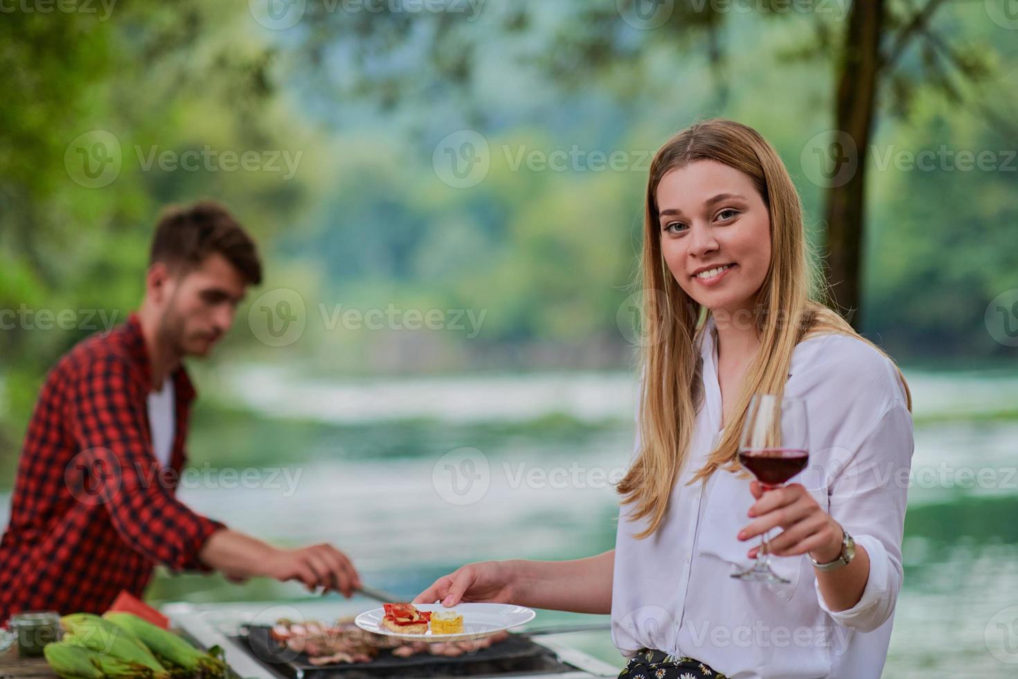 friends having picnic french dinner party outdoor during summer holiday photo