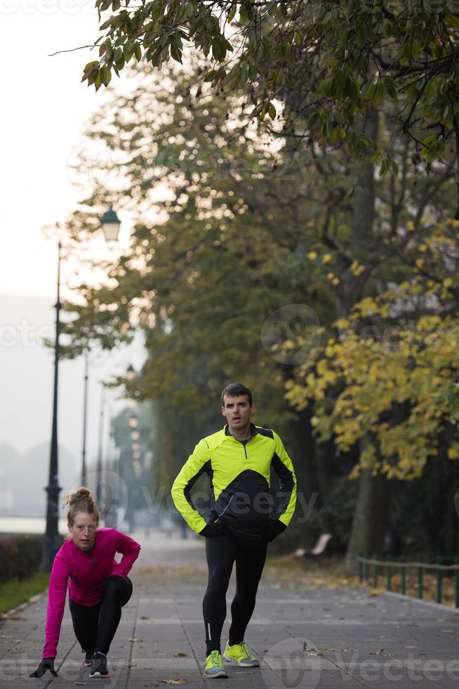 couple warming up before jogging photo