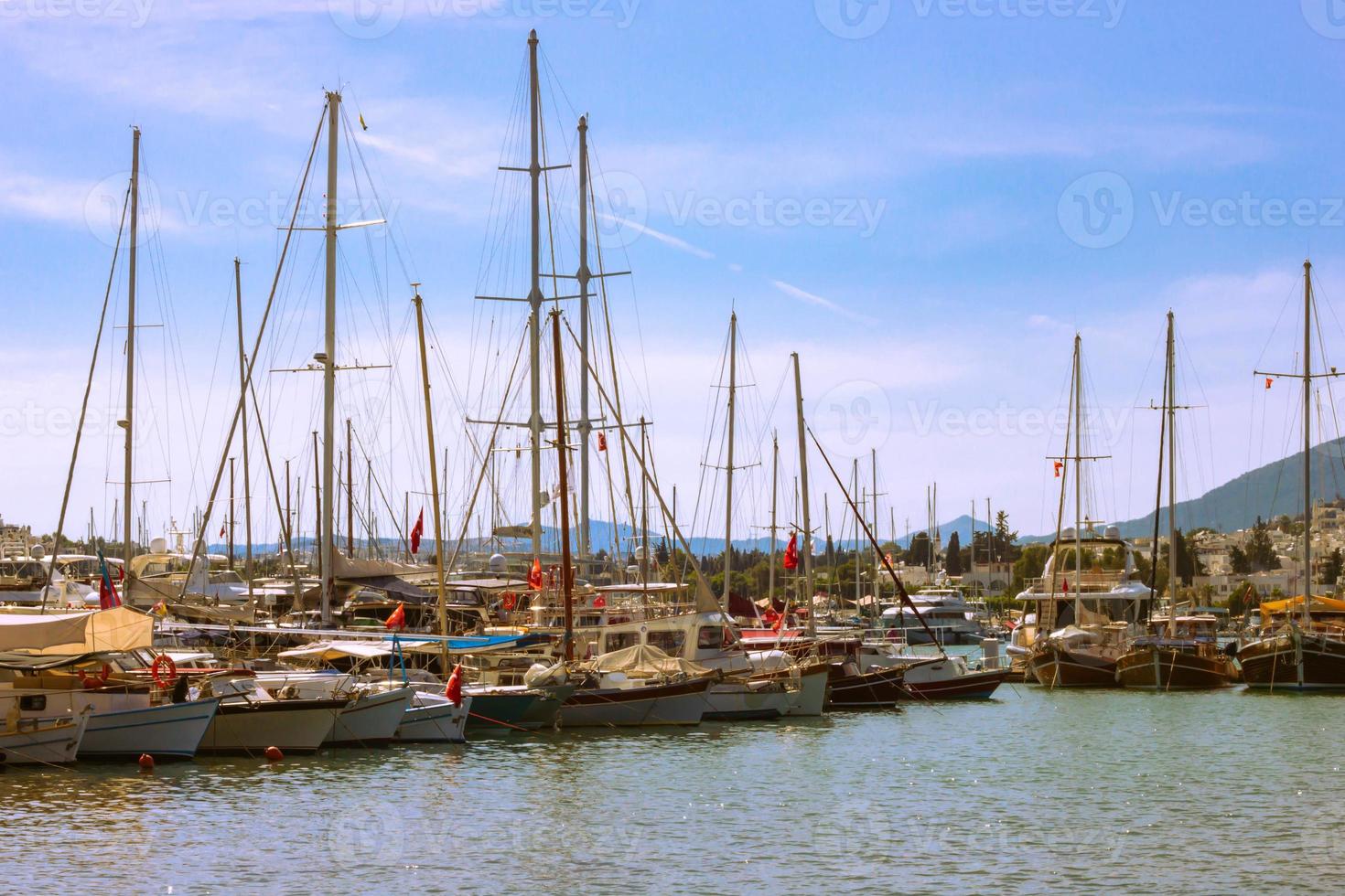 View of many yachts and boats moored at Bodrum harbor in a sunny summer day. photo