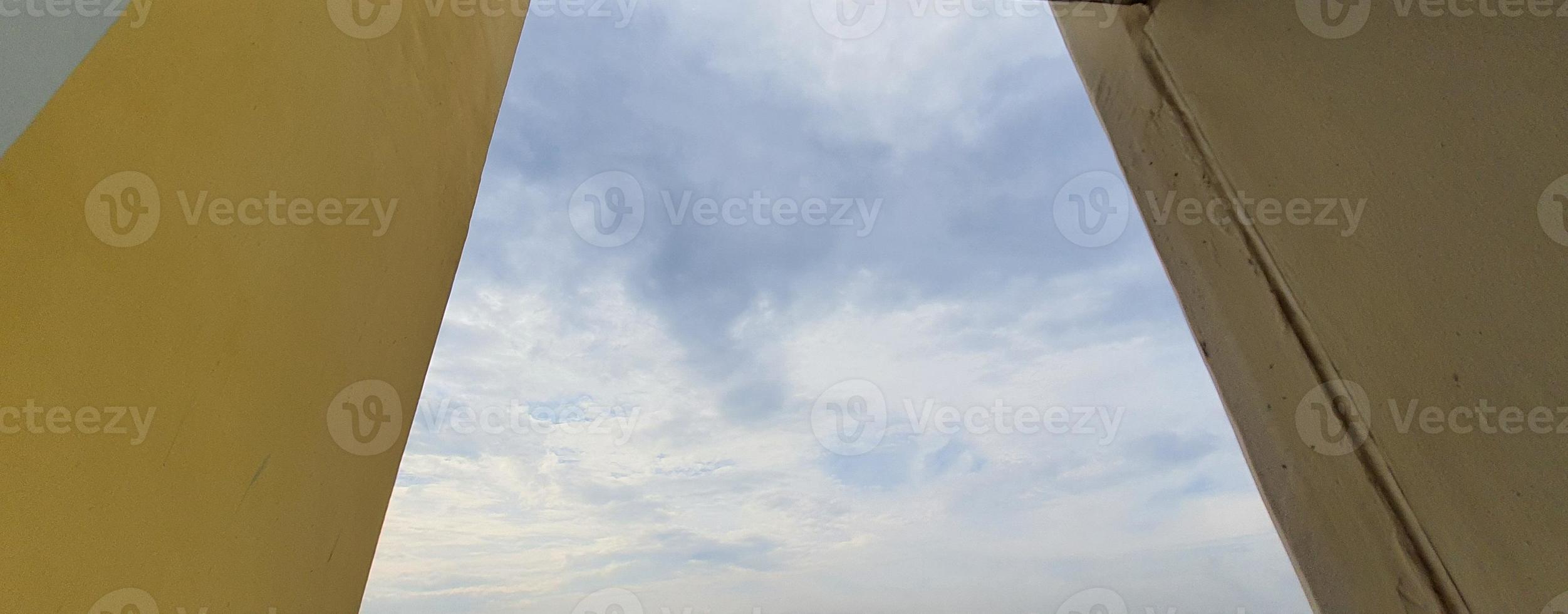 View of the sky between the building columns. photo