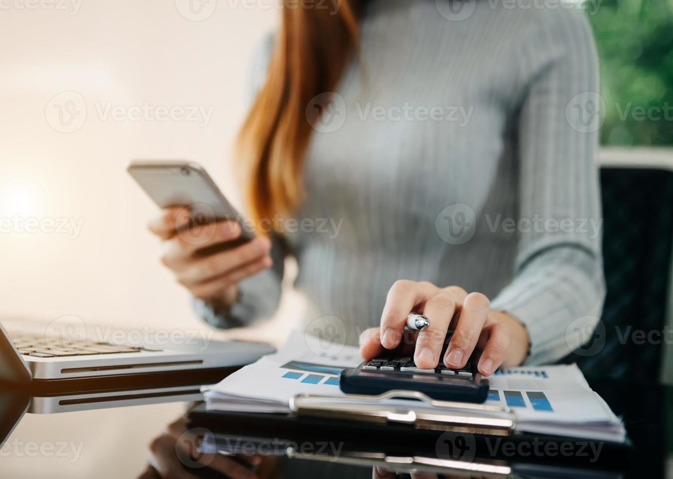 Businessman hands working with finances about cost and calculator photo