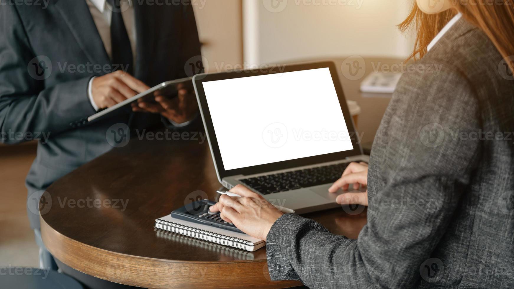 Business documents on office table with smart phone and calculator digital tablet and graph business with social network diagram and two colleagues discussing data working photo