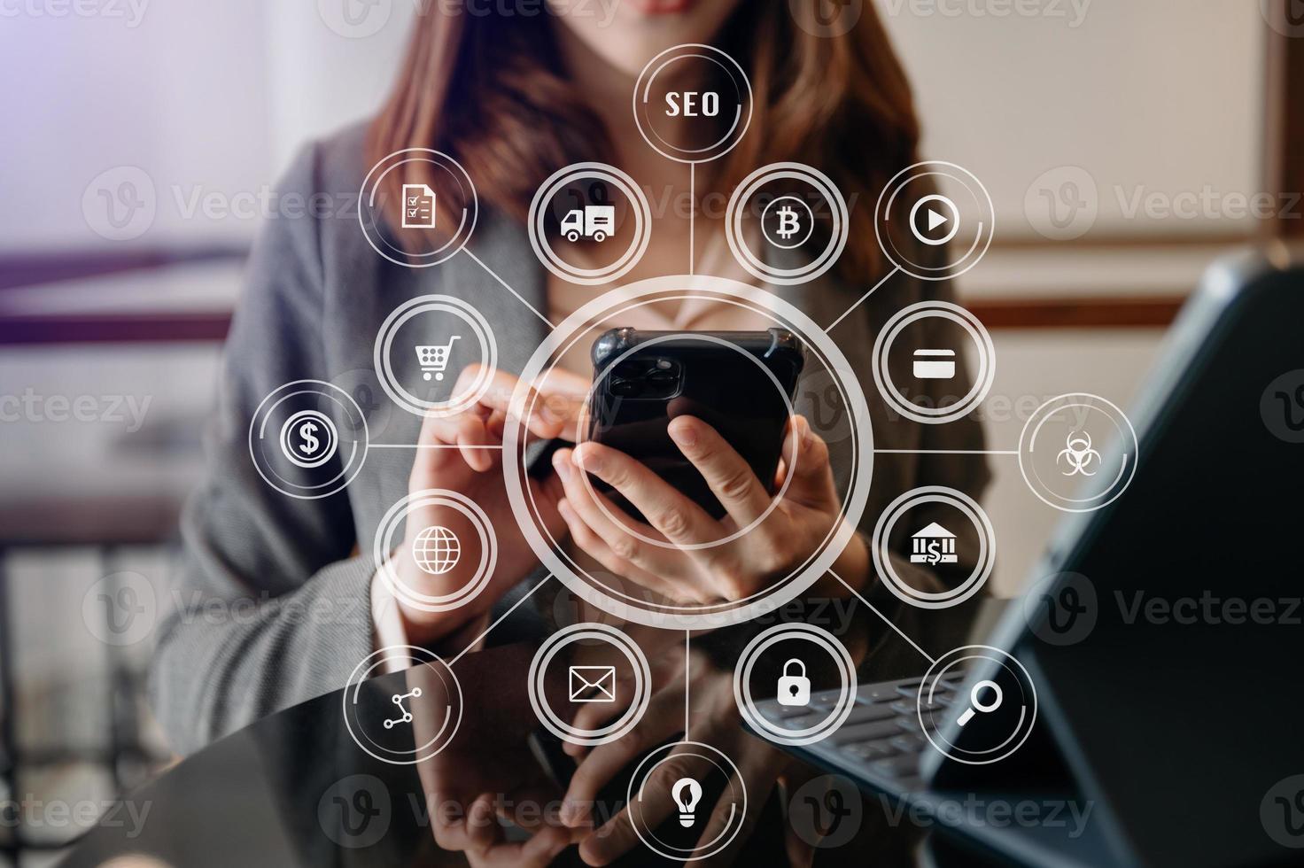 businesswoman or Designer using mobile phone with laptop and digital tablet laptop and document on desk in office with virtual icons network diagram i photo