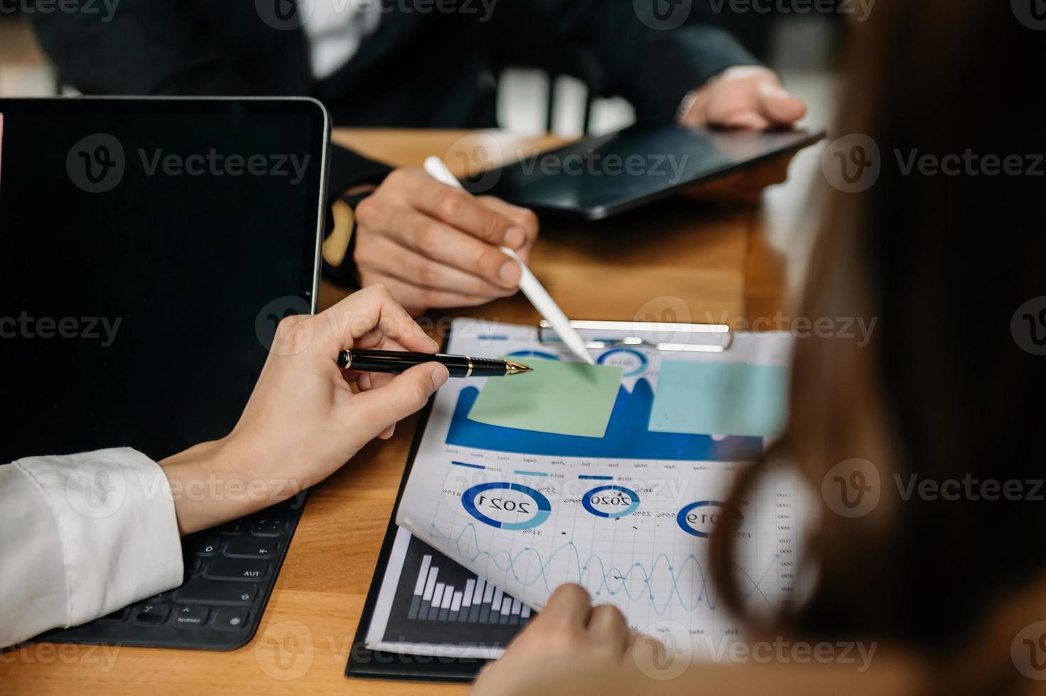 Team business meeting presentation. Hand businessman working project in modern office.Laptop computer and tablet and smart phone on white desk photo