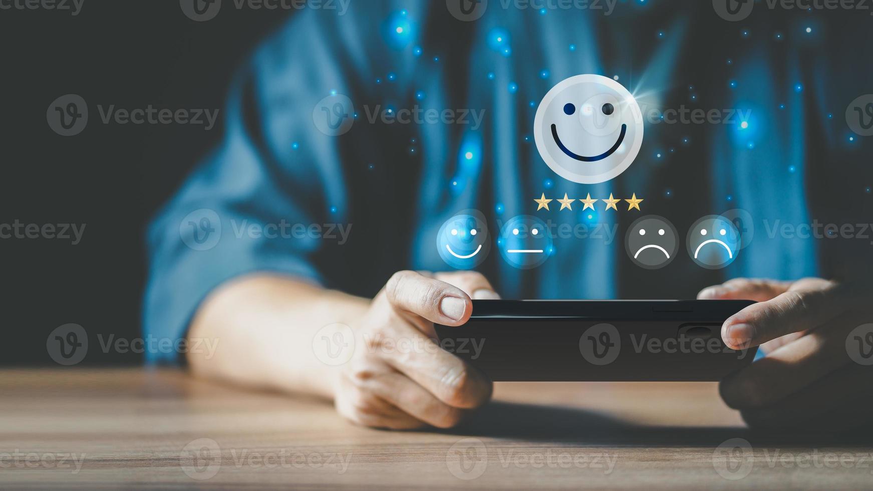 Man using a smartphone in give rating to service experience on application. Online customer review satisfaction feedback survey. photo