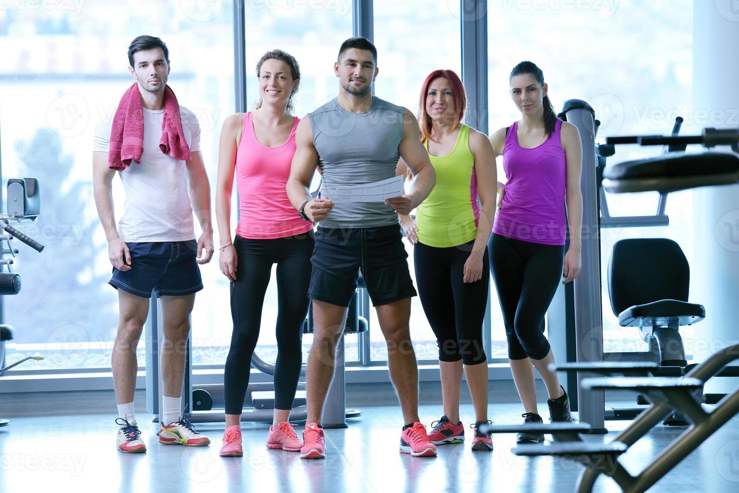 Group of people exercising at the gym photo
